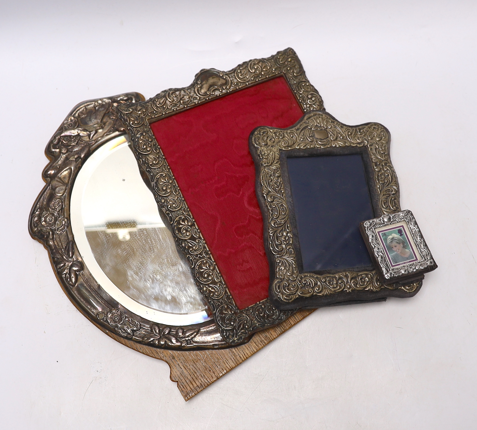 An Edwardian silver mounted wooden easel mirror, Birmingham, 1904, 31.4cm (a.f.), together with three assorted silver mounted photograph frames, earliest Birmingham, 1900.